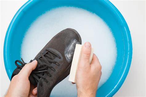 washing dirty shoes by hand.